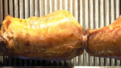 The meat carcass is rotated on a spit Stock Footage 130186923