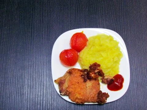 Meat chop with mashed potatoes and tomatoes Stock Photos