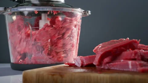 Meat is chopped up in a blender to make ground beef. Stock Footage 311885572