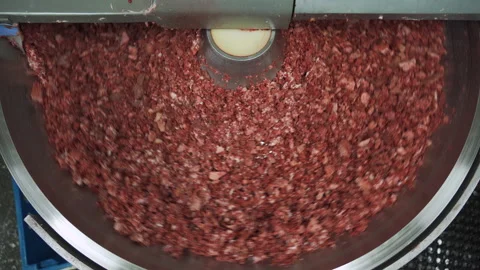Meat chopper machine, mixing meat and spices for making hot dogs and sausages. Stockbeeldmateriaal 131869802