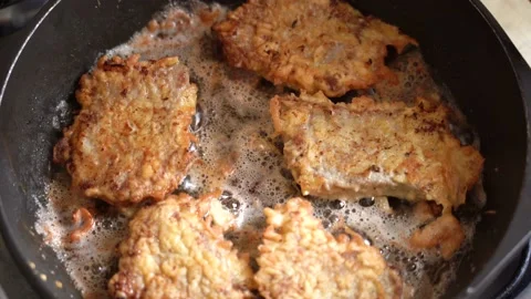 Meat chops are fried in boiling oil in hot frying pan. Top view Stock Footage 182003193