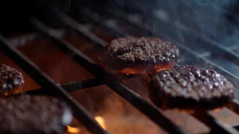 Meat chops for burger broils on fire at the restaurant Stock Footage 92685750