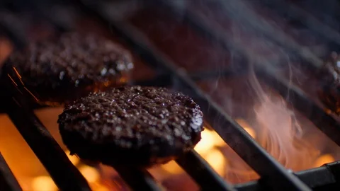 Meat chops for burger is on fire on grill Stock Footage 92684266