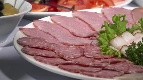 Meat cold cuts on the plate in the restaurant Stock Footage 74091058