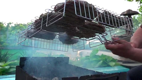 Meat cooked at bbq in the garden Stock Footage 131502862