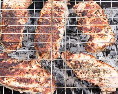 Meat is cooked on the grill. Close-up. Stock Photos