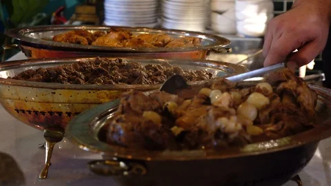 Meat cooked inside a traditional copper pot Stock Footage 99249794