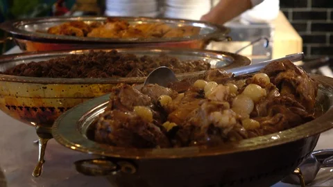 Meat cooked inside a traditional copper pot Stock Footage 99249859