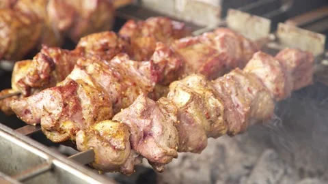 Meat is cooked on an open fire on the street. kebab. 스톡 동영상 131712561