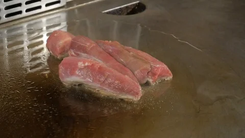 Meat is cooked on a professional cooker Stock Footage 87311809