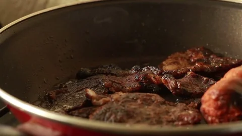 Meat cooking on frying pan Stock Footage 72834305