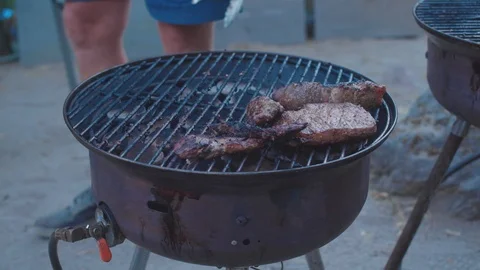 Meat cooking on a grill Stock Footage 103757253