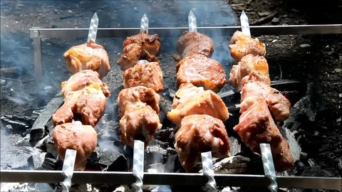 Meat cooking over and open fire BBQ Stock Footage 77861318