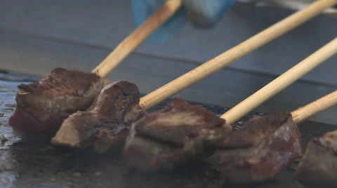 Meat cooking on sticks Stock Footage 47526387