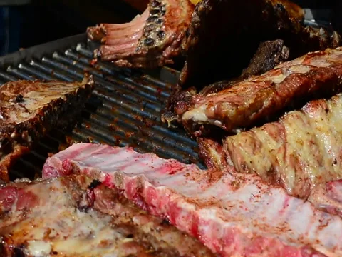 Meat cut in large pieces, almost ready, rotates on the grill Stock Footage 89662774