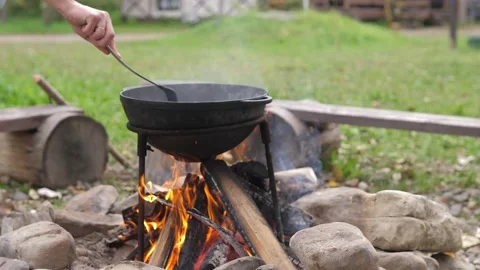 The meat is cut into pieces and built in oil in a cast iron cauldron. Cooking Stock Footage 220733070