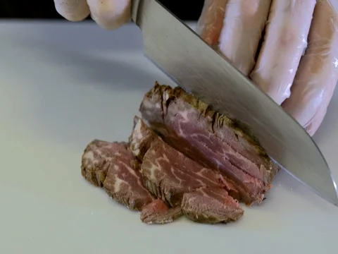 Meat is cut on the white Board. Slow motion Stock Footage 76053937