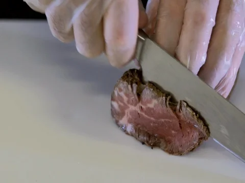 Meat is cut on the white Board. Slow motion Stock Footage 76056003