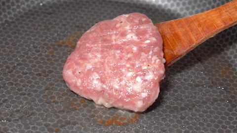 Meat cutlet is fried in a frying pan Stock Footage 247845273
