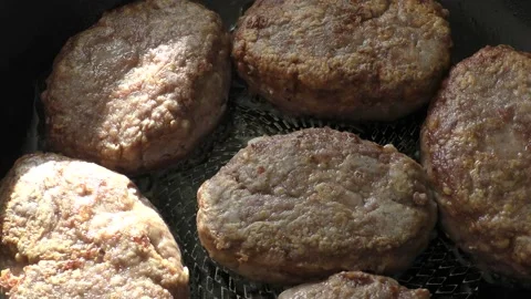 Meat cutlets are fried in a pan Stock Footage 162449664