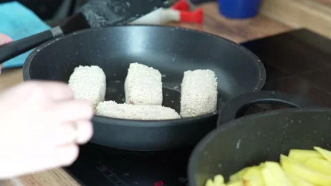 Meat cutlets are fried in pan. Chicken cutlets are fried in a black frying pan. Stock Footage 218323934