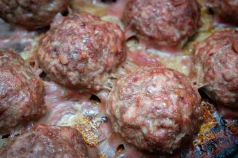 Meat cutlets cooked on a baking sheet in the oven Stock Photos