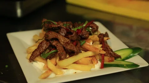 The meat dish is being prepeared to serve Stock Footage 65481460