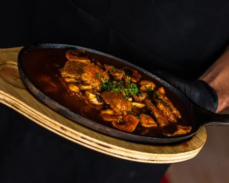 Meat dish with a bit of parsley Stock Photos