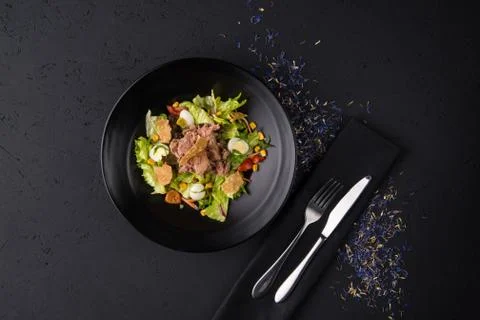 A meat dish on a black surface Stock Photos