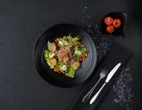 A meat dish on a black surface Stock Photos