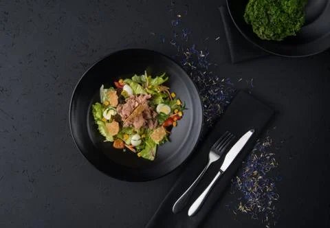 A meat dish on a black surface Stock Photos