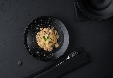 A meat dish on a black surface Stock Photos