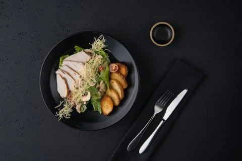 A meat dish on a black surface Stock Photos