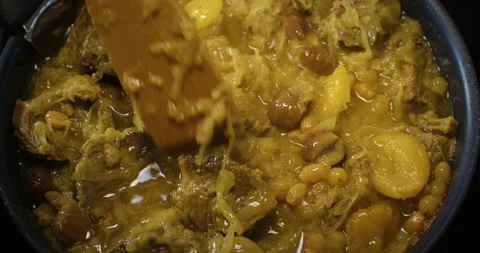 Meat dish cooked in a pot is mixed with a wooden spoon 스톡 동영상 155491087