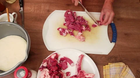 Meat dish - cutting steak slices onto cubes with sharp knife Stock Footage 44765561