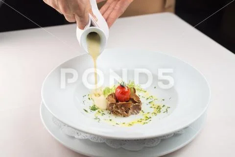 Meat dish with fried tomato poured with milk sauce Stock Photos