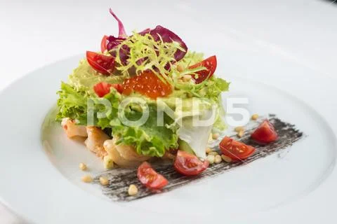 Meat dish with vegetables and red caviar Stock Photos