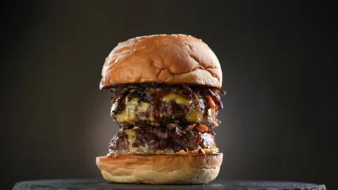 Meat double cheeseburger on black plate turntable on dark background. Stock Footage 170323858