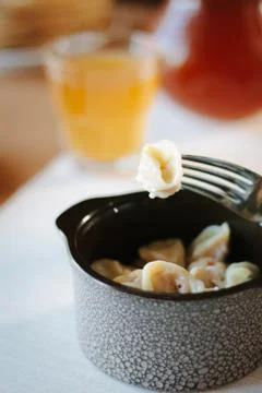 Meat dumpling on fork Stock Photos