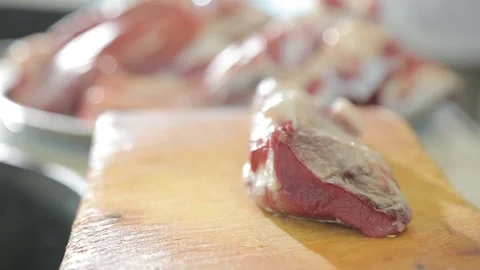 Meat falls on the table in slow motion (close-up) Video stock 145546512