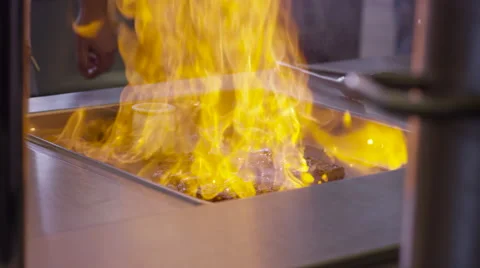 Meat flambe on fire Stock Footage 63840443