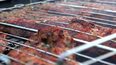 Meat is fried on a bbq in the garden Stock Footage 131502437