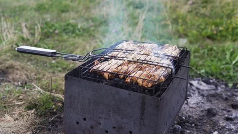 Meat is fried on coals on a brazier 库存影片 93745275