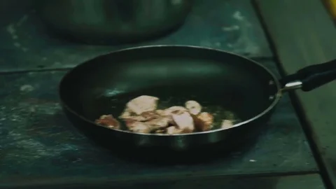 Meat is fried in a frying pan close-up Stock Footage 76583972