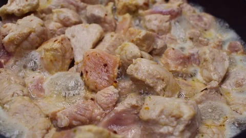 The meat is fried in a frying pan. Close-up. Stock Footage 94540165