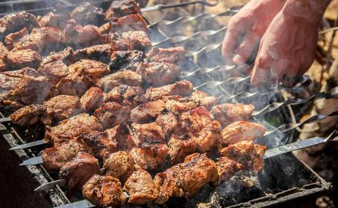 The meat is fried on the grill. Selective focus. Stock Photos