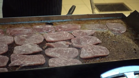 The meat is fried on a large stove. Stock Footage 100036945