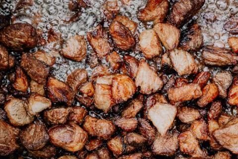Meat is fried in oil Stock Photos