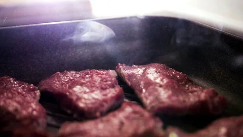 Meat is fried in a pan. Stock Footage 129290243