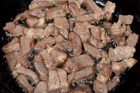 Meat fried in a pan Stock Photos